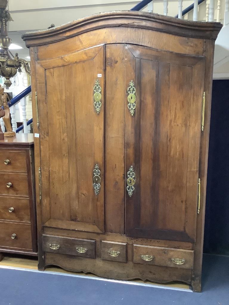 A large French knock-down armoire, with twin panelled doors over two long and one short central drawer, with polished brass mounts and handles, 18th century, width 160cm, depth 62cm, height 223cm